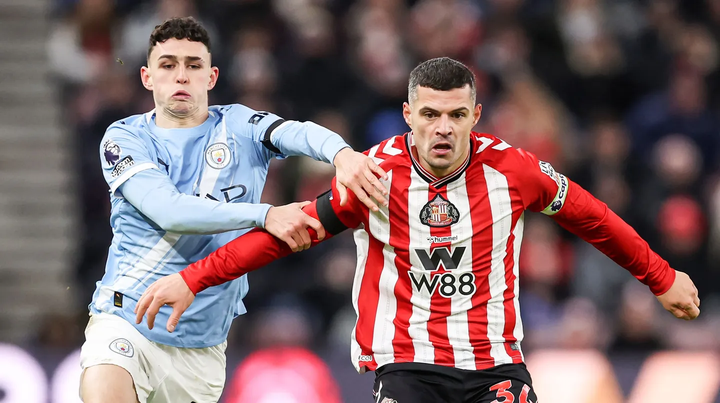 Granit Xhaka Of Sunderland Is Put Under Pressure By Phil Foden Of Manchester City