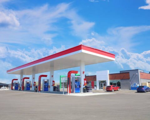 Modern Service Station With Convenience Store And A Few Cars, In A Sunny Day